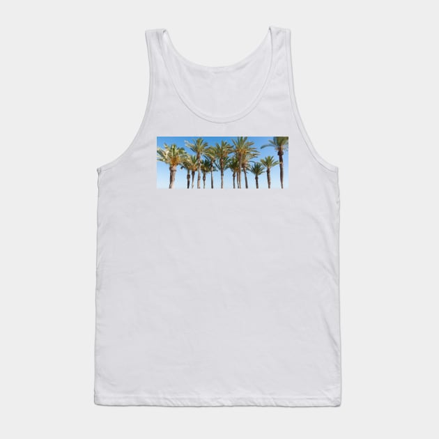 Row of tropical feeling palm trees against blue sky with luch green fronds. Tank Top by brians101